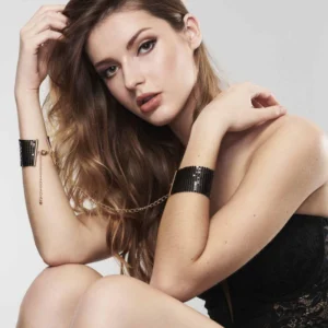 Woman wearing black Bijoux Indiscrets Desir Metallique Mesh Handcuffs as a bondage accessory