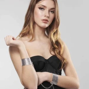 Woman wearing silver Bijoux Indiscrets Desir Metallique Mesh Handcuffs as a bondage accessory
