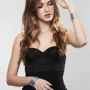 Woman wearing silver Bijoux Indiscrets Desir Metallique Mesh Handcuffs as a fashion accessory